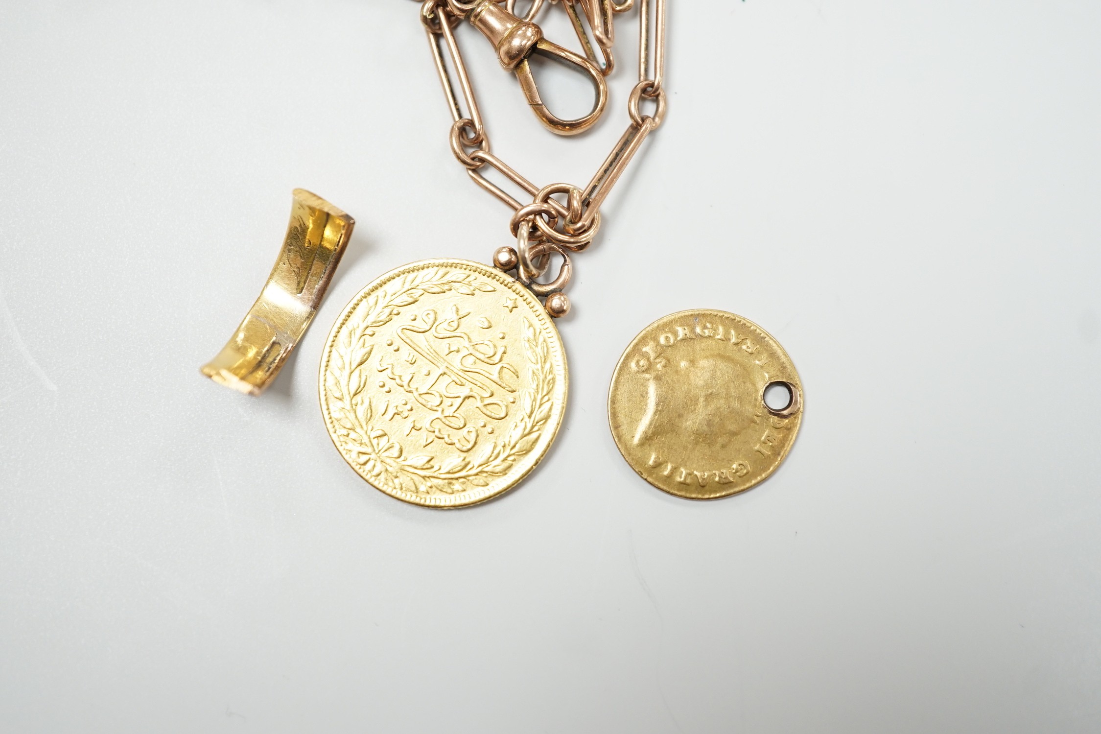 A Turkish 100 Karush gold coin, now mounted on a 9ct albert, chain 35cm, a gold one third guinea (worn and drilled) and a yellow metal shank section, gross weight 20.3 grams.